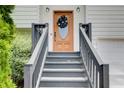 Close-up of the front door with black wreath, steps, and gray handrails at 8 Southview Dr, Cartersville, GA 30121