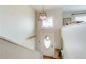 Bright foyer with decorative lighting, coat hooks, and wooden floors at 8 Southview Dr, Cartersville, GA 30121
