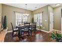 Traditional dining room with hardwood floors, a chandelier, and large windows at 1714 Indian Way, Cumming, GA 30040