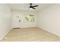 Bright living room with new flooring, a ceiling fan, and a door to the porch at 4523 Doc Sams Rd, Cumming, GA 30028