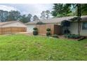 Nice backyard featuring a lawn, partial fence and some mature trees at 1150 Terramont Dr, Roswell, GA 30076