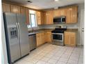 Kitchen boasts stainless steel appliances, stone countertops and tile flooring at 1150 Terramont Dr, Roswell, GA 30076