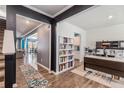 Open foyer featuring hardwood floors, a staircase, a built-in bookcase, a desk, and an adjacent dining area at 36 Ivy Chase Loop, Dallas, GA 30157