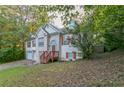 Two-story home with brick and vinyl siding, complemented by a red front door and lush greenery at 9444 Lakeview Ct, Douglasville, GA 30135