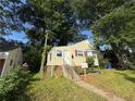 Charming one-story home featuring a sidewalk and short stairway to a welcoming front entrance at 1106 Donnelly Sw Ave, Atlanta, GA 30310