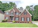 Inviting brick home with lush lawn, enhancing the property's appeal at 1988 Greensferry Gln, Lawrenceville, GA 30043