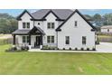 Stunning two-story home with a well-manicured lawn and a charming front porch at 2243 Cain Cir, Dacula, GA 30019
