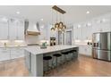 Bright kitchen featuring an island with barstool seating, pendant lighting, and stainless steel appliances at 2243 Cain Cir, Dacula, GA 30019