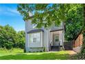 Charming two-story home with gray siding, black trim, and a well-manicured lawn at 900 Ira Sw St, Atlanta, GA 30310