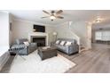 Inviting living room featuring hardwood floors, a fireplace, and modern furniture, perfect for relaxing and entertaining at 900 Ira Sw St, Atlanta, GA 30310