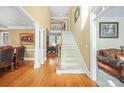 Bright foyer with hardwood floors, staircase, and views into the living areas at 1561 Annapolis Way, Grayson, GA 30017