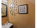 Cozy powder room featuring a vanity and decorative accents, creating a charming and functional space at 8566 Jamestown Way, Jonesboro, GA 30238