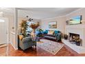 Inviting living room featuring a cozy fireplace, elegant furnishings, and warm hardwood flooring at 8566 Jamestown Way, Jonesboro, GA 30238