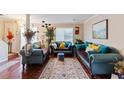 Comfortable living room with stylish sofas, decorative plants, and natural light streaming through the windows at 8566 Jamestown Way, Jonesboro, GA 30238