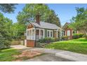 Charming home showcasing the side entrance, yard and landscaping on a sunny day at 1134 Jefferson Ave, East Point, GA 30344