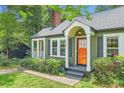 Charming home featuring a bright orange front door and well-kept landscaping at 1134 Jefferson Ave, East Point, GA 30344