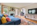 Cozy living room with a fireplace, hardwood floors, and comfortable blue sectional sofa at 1134 Jefferson Ave, East Point, GA 30344