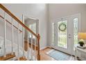 Inviting foyer featuring hardwood floors, decorative front door with sidelights, and access to staircase at 2081 Township Dr, Woodstock, GA 30189