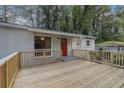 Spacious wooden deck offering an ideal space for outdoor enjoyment, complete with access to the front door at 726 Alfred Nw Rd, Atlanta, GA 30331