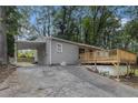 Well-maintained house with a carport and a wooden deck, accessible via a concrete driveway and backyard at 726 Alfred Nw Rd, Atlanta, GA 30331