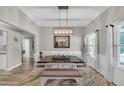 Elegant dining room with modern lighting, neutral tones, and stylish furnishings at 5105 Ashley Falls Ct, Loganville, GA 30052