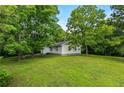 This cozy home showcases a spacious, well-kept yard perfect for outdoor enjoyment, blending seamlessly with nature's beauty at 1179 Chatham Rd, Buford, GA 30518
