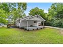 Inviting home with a covered front porch and landscaped greenery, showcasing a peaceful outdoor setting, and a side carport at 1179 Chatham Rd, Buford, GA 30518