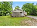 Welcoming facade with a covered porch, landscaped greenery and a side carport adding charm to this beautiful home at 1179 Chatham Rd, Buford, GA 30518