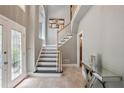 Elegant foyer featuring a staircase, decorative console table, and tiled floors that create a welcoming entrance at 4341 Horder Ct, Snellville, GA 30039