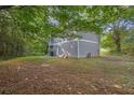 Large backyard featuring mature trees and a grassy area, providing ample space for outdoor activities and relaxation at 3498 Newberry Trl, Decatur, GA 30034