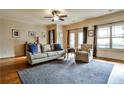 Bright living room with hardwood floors, a ceiling fan, and comfortable seating arrangement with natural light at 680 Emeril Dr, Avondale Estates, GA 30002