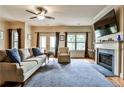 Comfortable living room featuring a fireplace, TV, hardwood floors, and access to an outdoor deck at 680 Emeril Dr, Avondale Estates, GA 30002