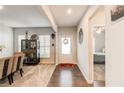 Welcoming entryway with a wood floor hallway and an adjacent carpeted dining area at 230 Mackenzie Ct, Covington, GA 30016