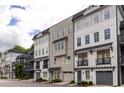 Beautiful townhouse row featuring multi-story buildings, private garages, and architectural details at 24 Becker Nw Pl, Atlanta, GA 30307