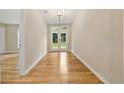 Bright hallway featuring hardwood floors and a view of the backyard through glass doors at 2552 Scenic S Hwy, Snellville, GA 30078