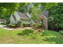 Traditional home exterior with brick and siding accents, surrounded by mature trees and landscaping at 46 Highland Ct, Carrollton, GA 30116