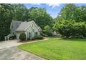 Charming home with a manicured lawn and lush greenery, showcasing its inviting curb appeal at 46 Highland Ct, Carrollton, GA 30116