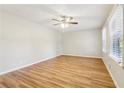 Spacious bedroom with hardwood floors, a ceiling fan, and large windows for ample natural light at 6071 Cristie Dr, Ellenwood, GA 30294