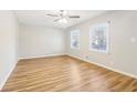 Light filled bedroom features wood flooring, neutral walls, ceiling fan and double window at 6071 Cristie Dr, Ellenwood, GA 30294