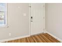Bright entryway featuring a white front door, wood-look flooring, and a window for natural light at 6071 Cristie Dr, Ellenwood, GA 30294