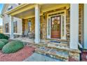 Inviting front porch with stone accents and a decorative wreath on the front door at 2837 Captain Ct, Dacula, GA 30019