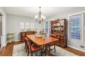Traditional dining room with a wood table, china cabinet, chandelier, and a large window, perfect for Gathering gatherings at 159 Cavan Se Way, Mableton, GA 30126