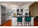 Contemporary kitchen with white cabinetry, stainless appliances, black countertop, and hardwood floors at 3334 Peachtree Ne Rd # 1707, Atlanta, GA 30326