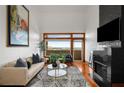 Spacious living room with a fireplace, hardwood floors, and floor to ceiling windows offering nice views at 3334 Peachtree Ne Rd # 1707, Atlanta, GA 30326