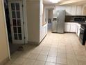 Functional kitchen with tiled floor, stainless steel refrigerator and a doorway entrance at 4485 Merlin Ne Cir, Douglasville, GA 30134