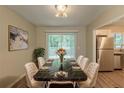 Elegant dining room with a black marble table, seating for eight, and stainless steel appliances in the kitchen at 4669 Birch Ridge Trl, Stone Mountain, GA 30083
