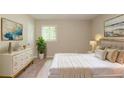 Calm main bedroom with neutral tones, large bed, elegant dresser and natural lighting from the window at 4669 Birch Ridge Trl, Stone Mountain, GA 30083