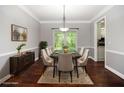 Elegant dining room with modern lighting, a large window, and sophisticated decor at 6435 Ivey Creek Cir, Cumming, GA 30040