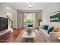 Cozy living room with natural light, comfortable seating, and a view of the outdoors at 6435 Ivey Creek Cir, Cumming, GA 30040