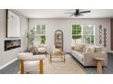 Bright living room with a modern fireplace, large windows, and stylish decor for a comfortable living space at 947 Edwin Ln, Sugar Hill, GA 30518